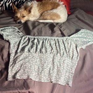 PAC cares, size medium, pastel teal with white floral pattern.